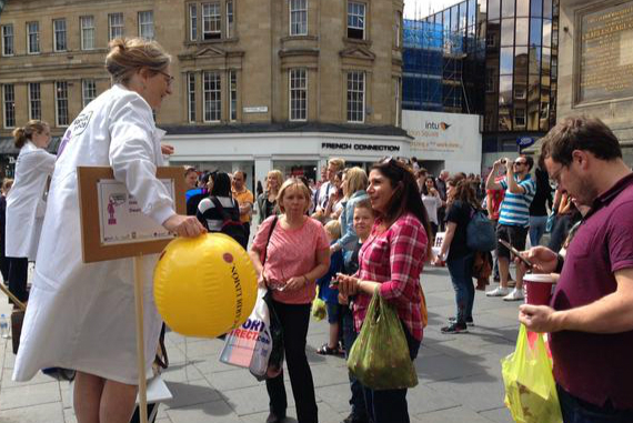 Female scientist showcasing her research on the streets of Newcastle as part of the 2015 Soapbox Science event